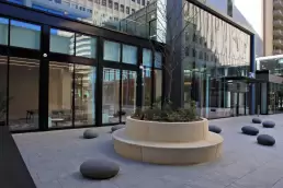 Century Center I + II after commercial office renovation, showing modern glass facades, new public plaza, landscaped courtyards, and updated street-level pedestrian experience in Arlington, Virginia.